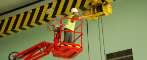 Worker on manlift working high off the ground.